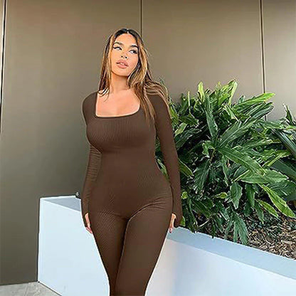 Brown seamless long-sleeve yoga jumpsuit worn by a woman outdoors, showcasing a sleek and stylish design.